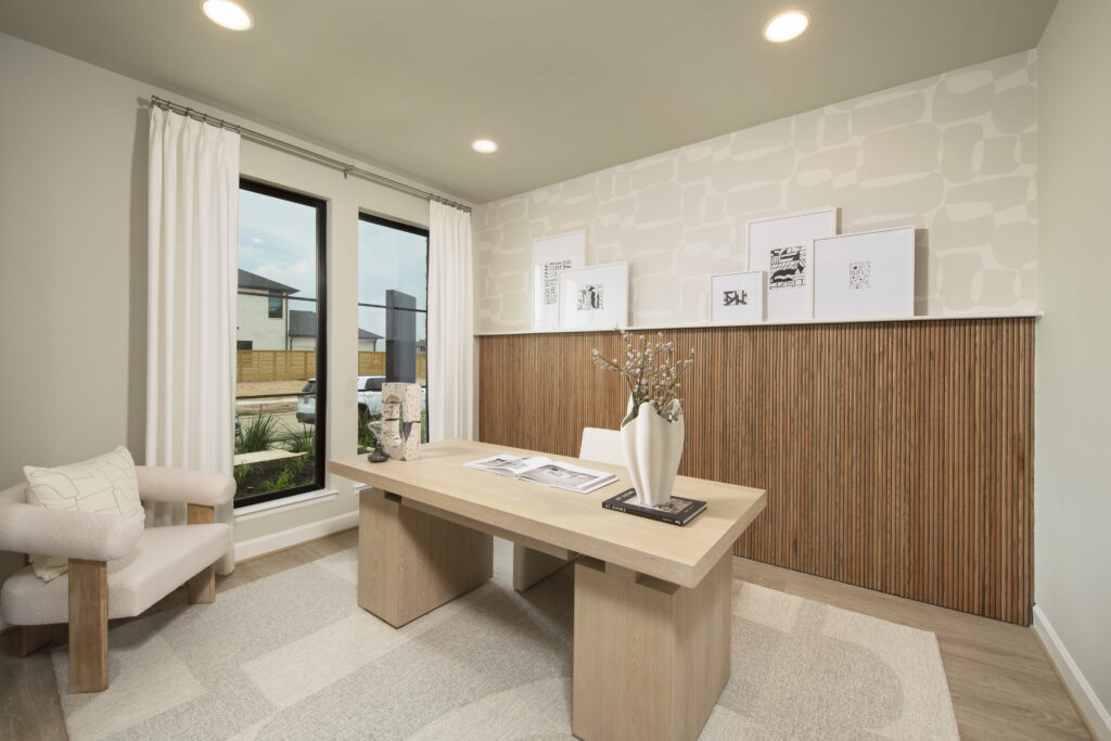 Stylish home office with wood slat accent wall and large windows in Perry Homes 60' model at Austin Point