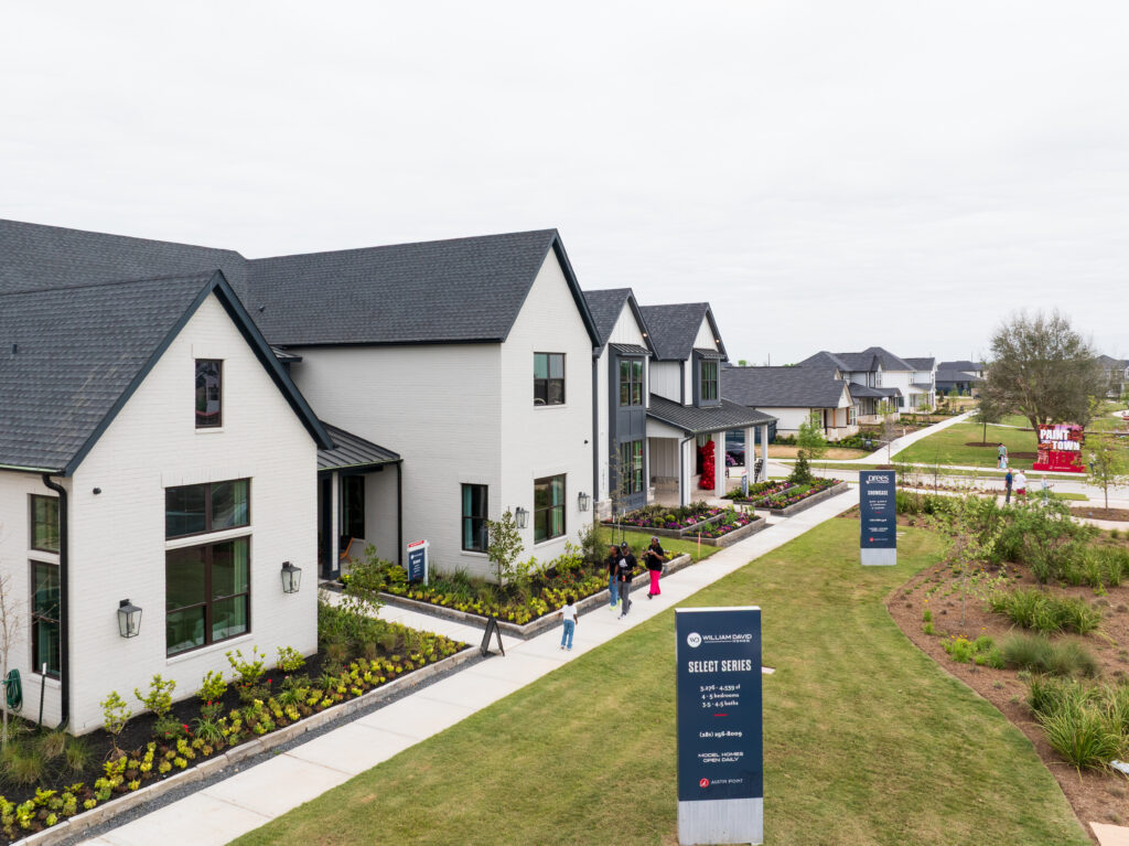 Visitors walking between model homes during the Austin Point grand opening home tour.