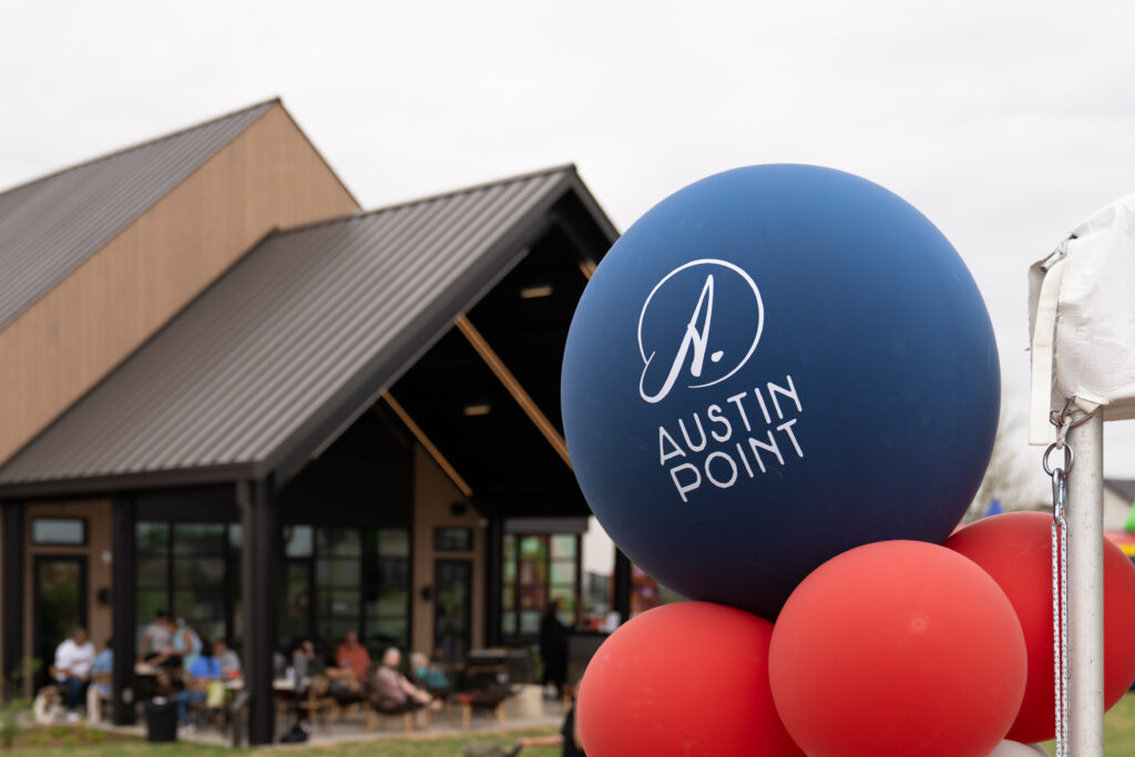 Austin Point balloon display in front of The 1824 community gathering space during the grand opening celebration.