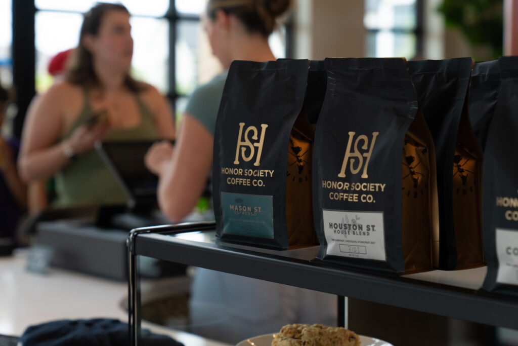 Bags of Honor Society Coffee on display inside Honor Society at The 1824 café at Austin Point during the community's phase one grand opening festival.