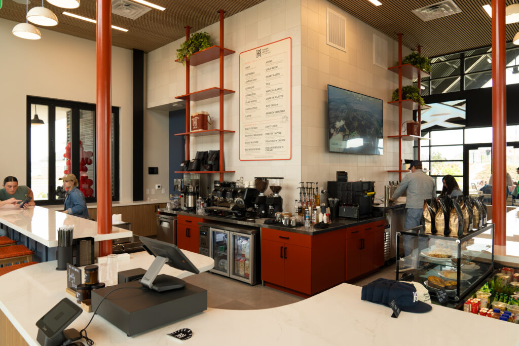 Interior view of Honor Society at The 1824 featuring coffee bar seating, espresso equipment, and specialty coffee offerings.