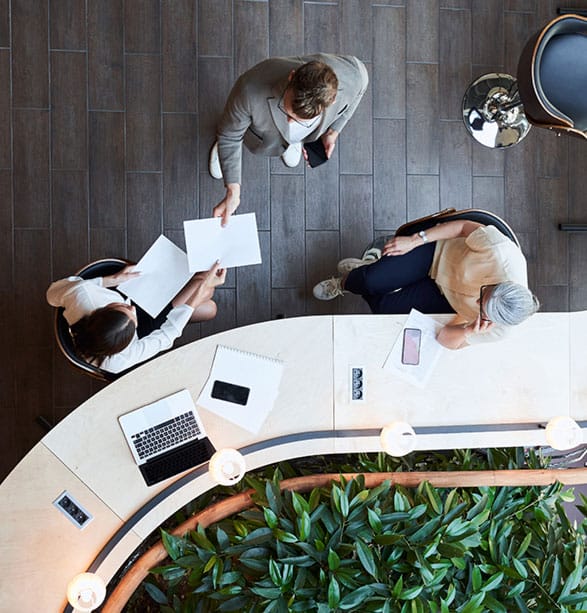 overhead shot of business people talking at a counter in an office