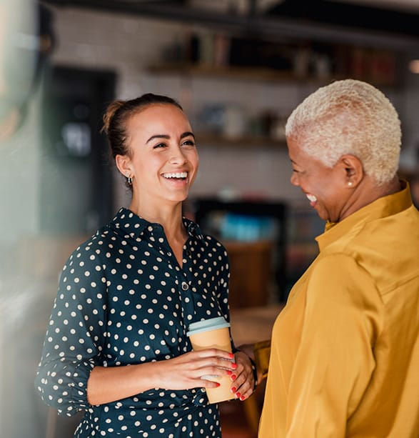 Two business women having a convesation face to face